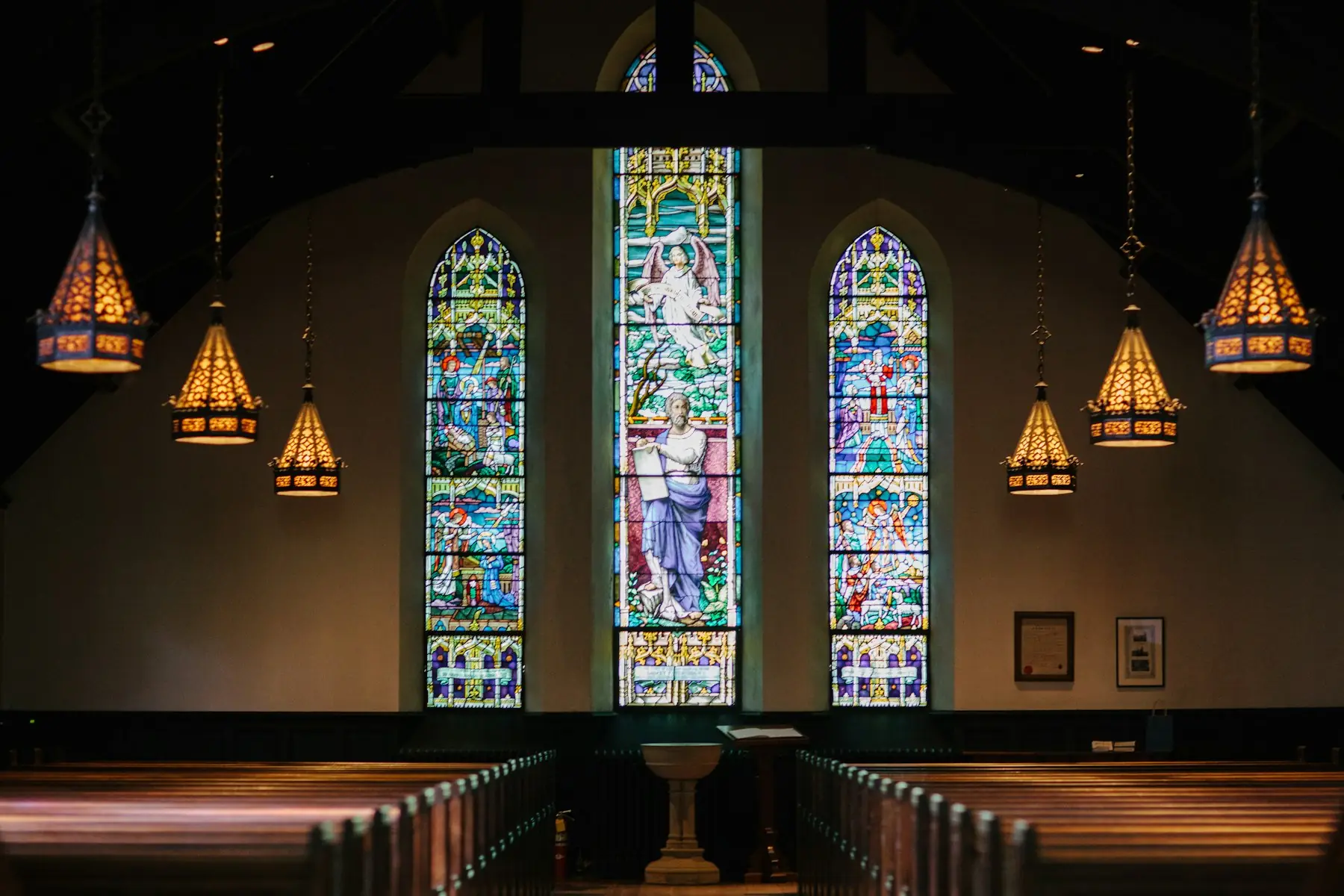Church interior with stained glass windows and pews