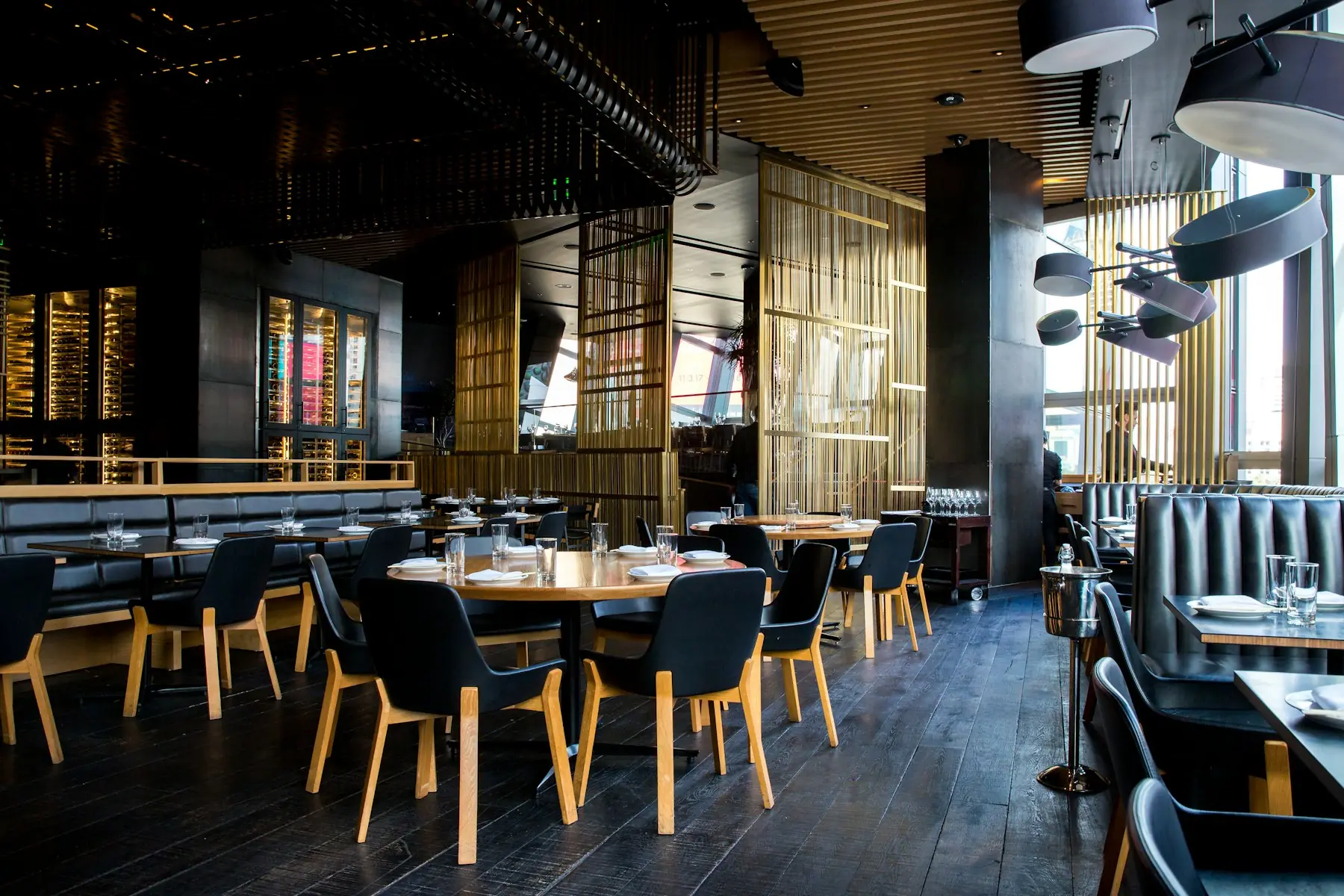 A restaurant dining room with wood tables
